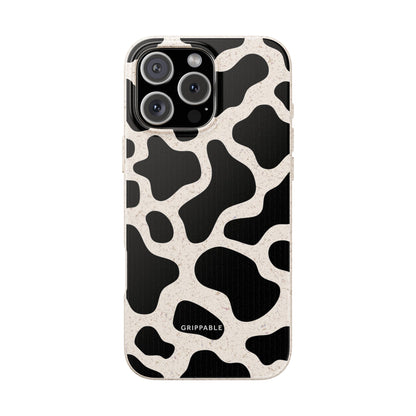 Phone case with black and white cow print pattern on a white background