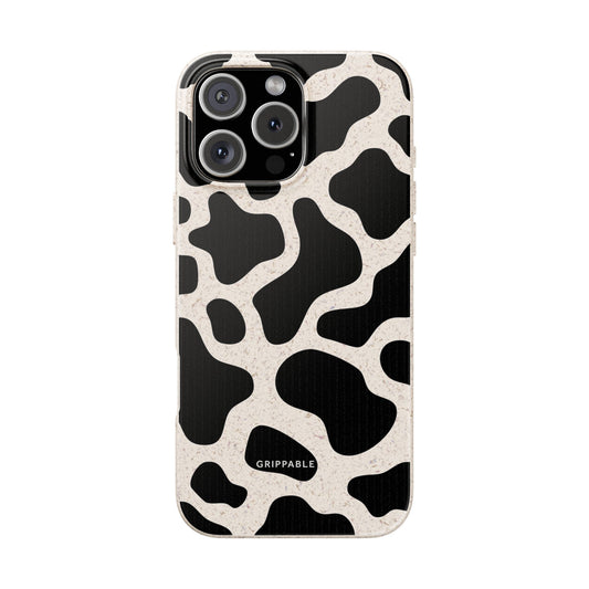 Phone case with black and white cow print pattern on a white background